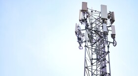 cell tower standing with light blue sky in the background