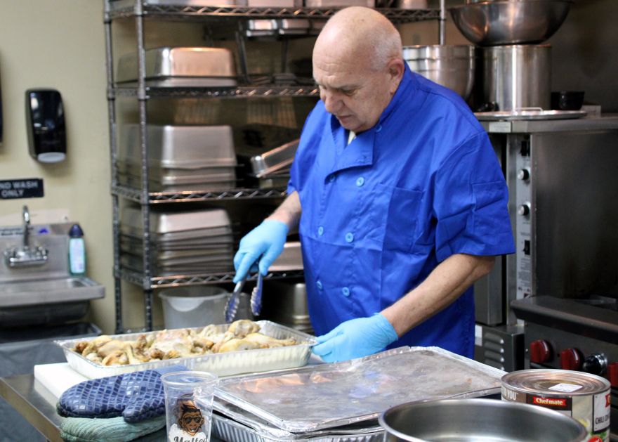 Todd Powers, Avenue of Life's nutrition specialist, prepares lunches for families that attend Impact Wednesdays.