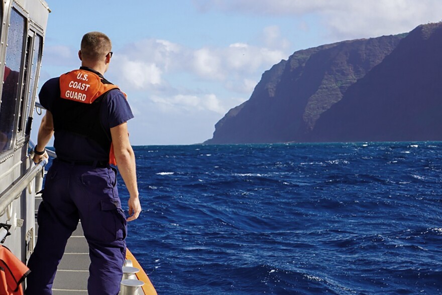 In this photo released by the U.S. Coast Guard, Coast Guard Cutter William Hart moves toward the Nā Pali Coast on Kauaʻi on Friday, Dec. 27, 2019, the day after a tour helicopter disappeared with seven people aboard. (MK3 Forest Herring/U.S. Coast Guard via AP)