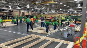 John Deere Harvester Works employees work on building wood frames for a Habitat for Humanity house at the East Moline plant, Friday, May 29, 2026.