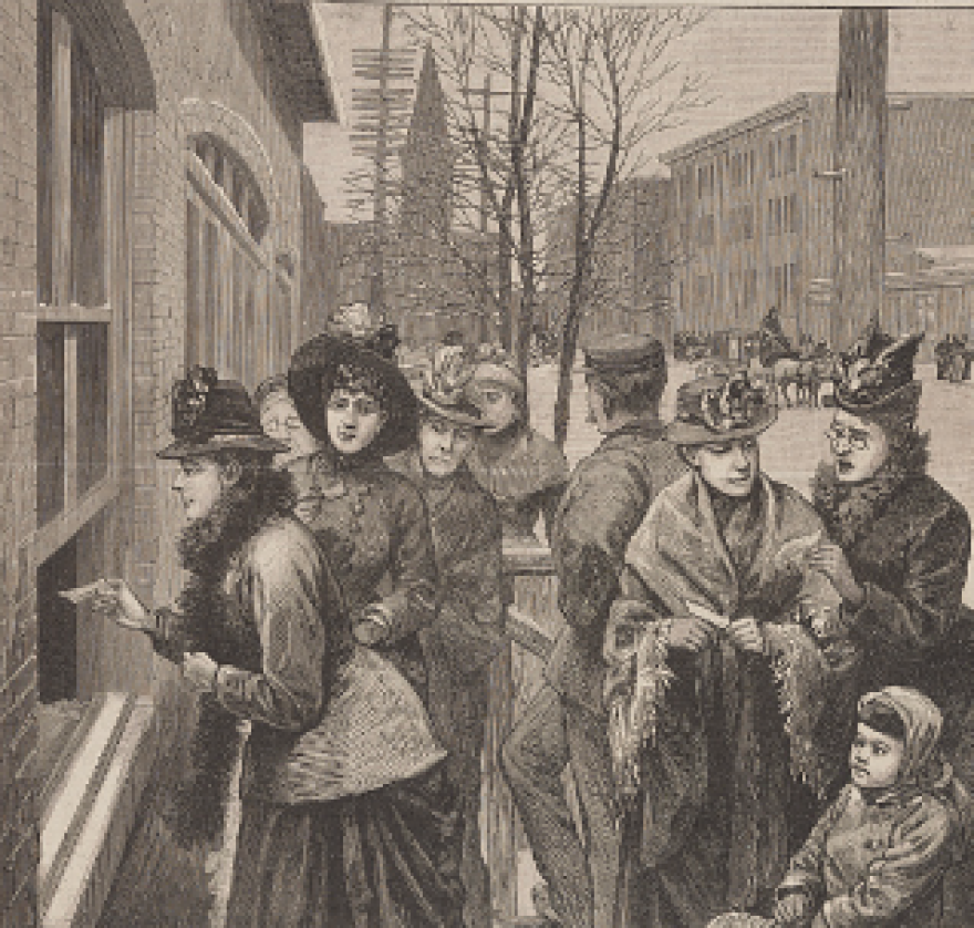 A black and white illustration of a group of women wearing historic clothing out on the street, with one of them handing a piece of paper through a window.