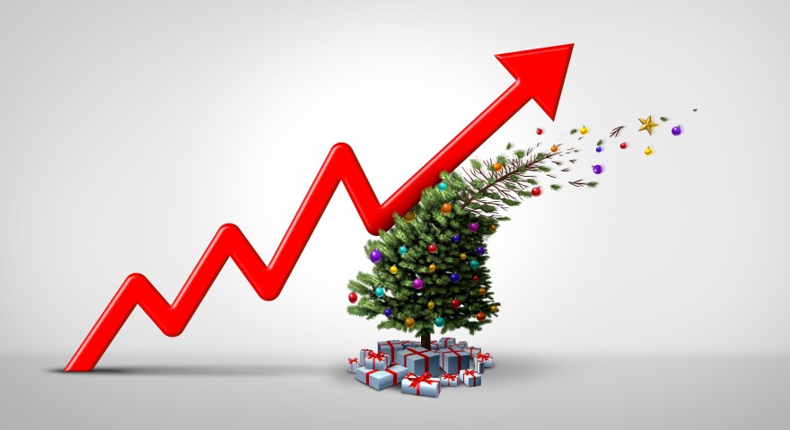 A graphic of a jagged red arrow moving upward and knocking over a decorated Christmas tree