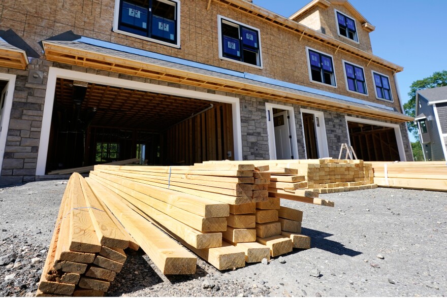 Lumber is piled at a housing construction site.