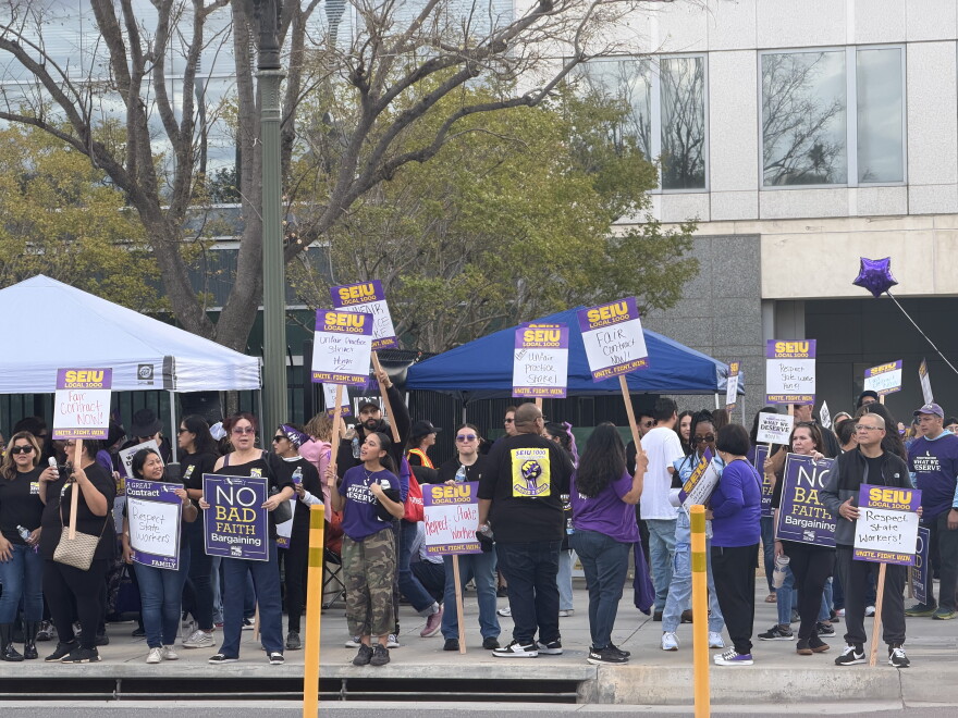 State workers picket outside the Rosa Parks Memorial Building in San Bernardino on Oct. 21, 2026, as part of a statewide SEIU Local 1000 strike calling for higher wages, better health care benefits and more flexible working conditions.