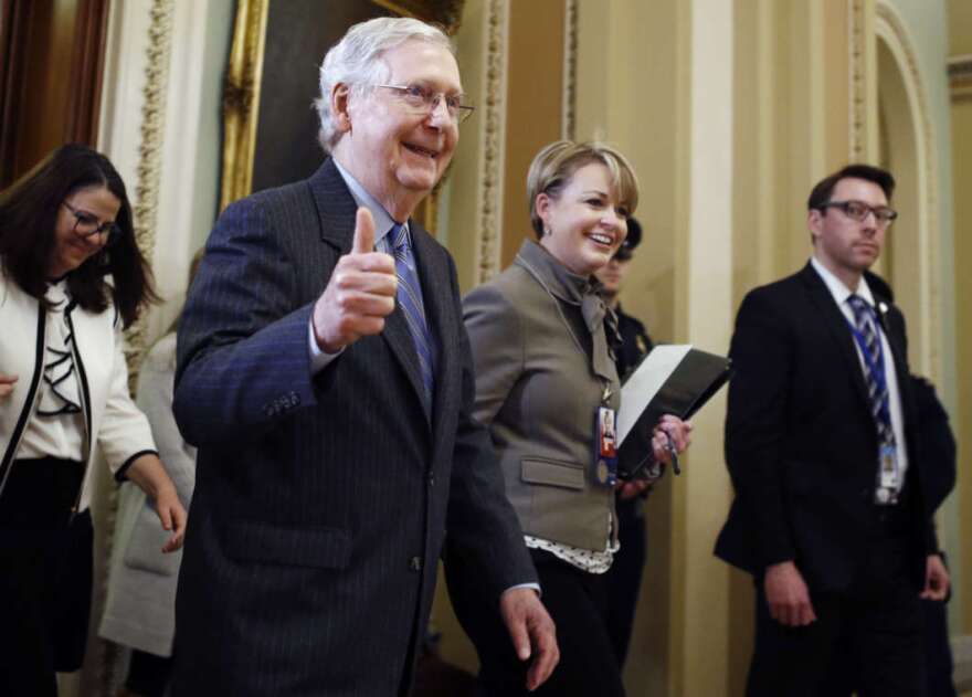 Senate Majority Leader Mitch McConnell, R-Ky., gives a thumbs up as he leaves the Senate chamber during the impeachment trial of President Trump on Friday.