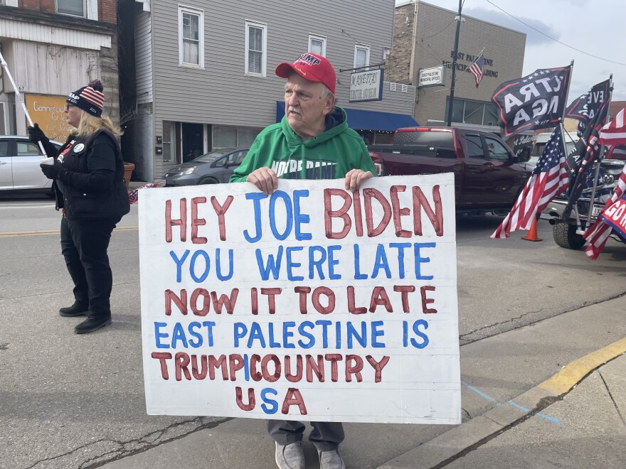 Don Skowron stands with a sign that reads, "Hey Joe Biden. You were late. Now it's too late. East Palestine is Trump country U.S.A.," in Downtown East Palestine. 