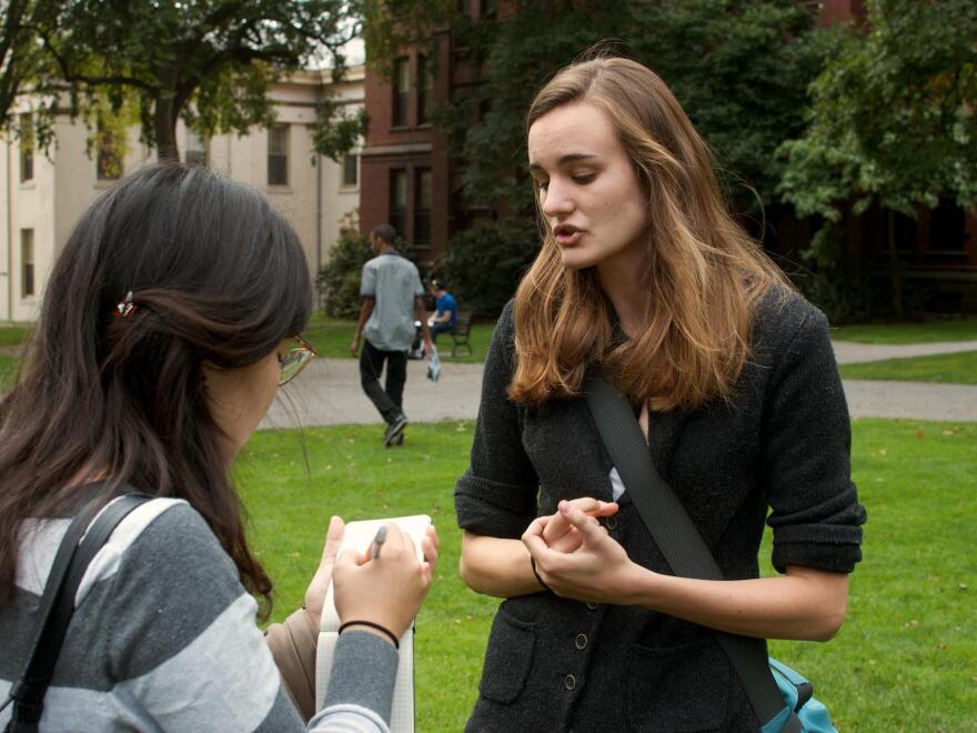 Brown University senior Emily Kirkland (right) speaks with a student newspaper reporter. Kirkland, who studies environmental science, has been leading a divestment campaign at Brown and says she has seen how powerful such protests can be. "Our administration is taking us very seriously," she says.