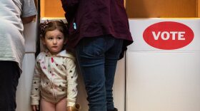 Kinsley Ellis, then 3, stood next to her mom and grandmother while they voted in polling stations at the Pottawatomie County Election Board in Shawnee on Nov. 1, 2018, the first day of early voting.