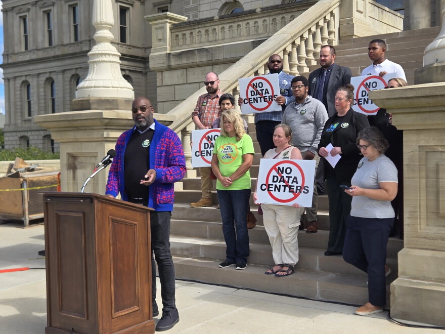 Kendell Joseph stands at the Michigan Capitol with a group opposing data centers.