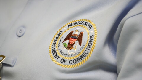 The logo of the Mississippi Department of Corrections is shown on the shirt of a corrections officer on Tuesday, May 9, 2023, at Central Mississippi Correctional Facility in Pearl, Miss.