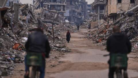 A Palestinian woman walks along a street surrounded by buildings destroyed during Israeli air and ground operations in the Sheikh Radwan neighborhood, in Gaza City, Tuesday, Dec. 30, 2025. (Abdel Kareem Hana/AP)