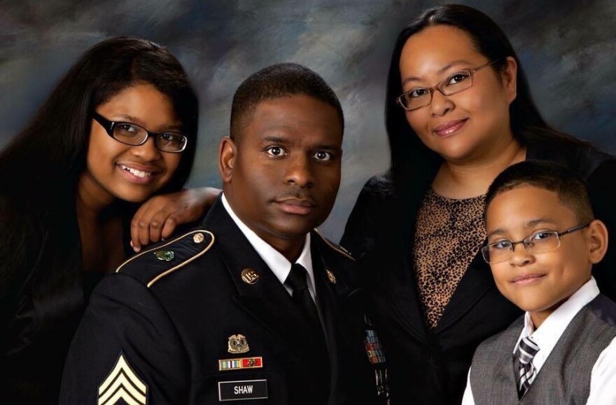 Shaw is surrounded by his family. From left, daughter Sarah, wife Valerie and son Tyree.