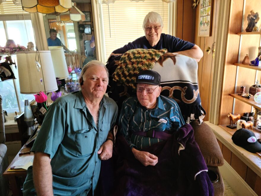 Doyle Lutz (in the chair) with his wife Eunice and son Robert.