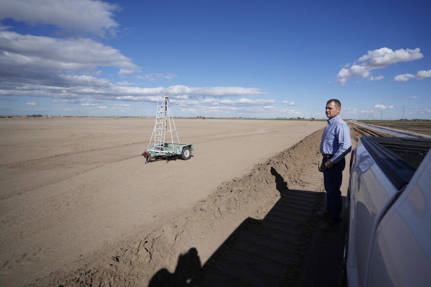 FILE - Tom Brundy looks over his field that is being prepared for planting near Calexico, Calif., Feb. 28, 2023.