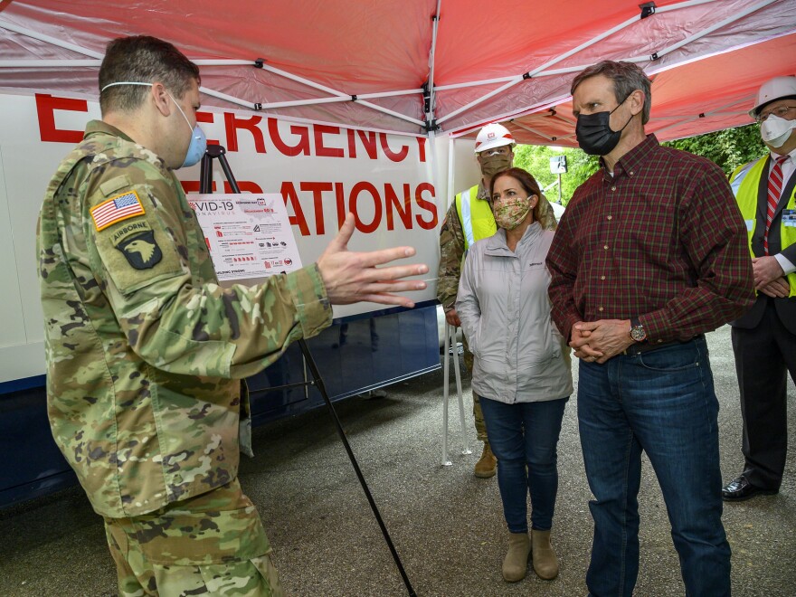 Tennessee Gov. Bill Lee (right) tours a temporary hospital site in April with his wife, Maria Lee. The overflow hospital, intended to help with the surge in COVID-19 hospitalizations, won't be able to take patients if there aren't additional doctors and nurses available to provide treatment.