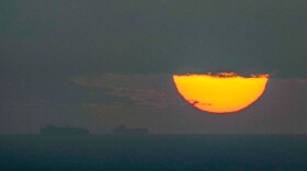 FILE - Ships sail through the Arabian Gulf toward the Strait of Hormuz as the sun sets in the United Arab Emirates Monday, March 23, 2026. (AP Photo, File)