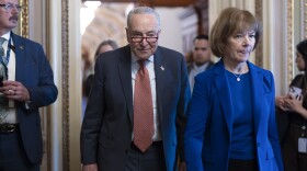 Senate Minority Leader Chuck Schumer, D-N.Y., left, walks with Sen. Tina Smith, D-Minn., as Senate Democrats gather behind closed doors to mount a last-ditch protest over a Republican-led spending bill that already passed the House, at the Capitol in Washington, Thursday, March 13, 2025. (AP Photo/J. Scott Applewhite)
