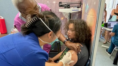 Damien Burkholder gets a Tdap shot at the Sacramento City Unified vaccination clinic in 2023 in preparation for the beginning of the school year.