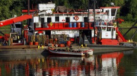 In this Aug. 22, 2012, A boat is seen dredging the Illinois River south of Havana, Ill. 