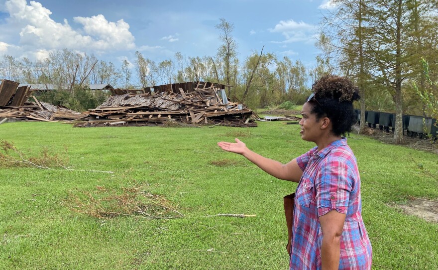 Joy Banner points to the two sharecropper cabins that were flattened by Hurricane Ida's ferocious winds.