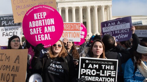 Pro-abortion-rights activists hold signs alongside anti-abortion-rights activists outside the Supreme Court last month.