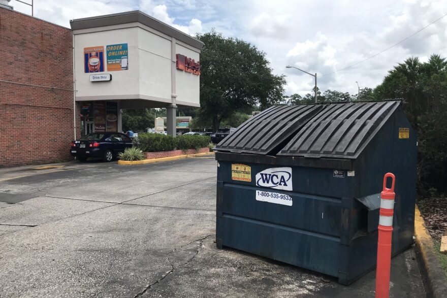 A WCA dumpster sits behind the Gainesville location of Cuban restaurant Mi Apa. Food waste and contaminated reusable products wind up here. (Joshua Baker/WUFT News)