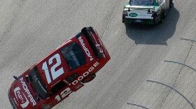 Brad Keselowski (12) flips after being nudged by Carl Edwards, top, at Atlanta Motor Speedway.