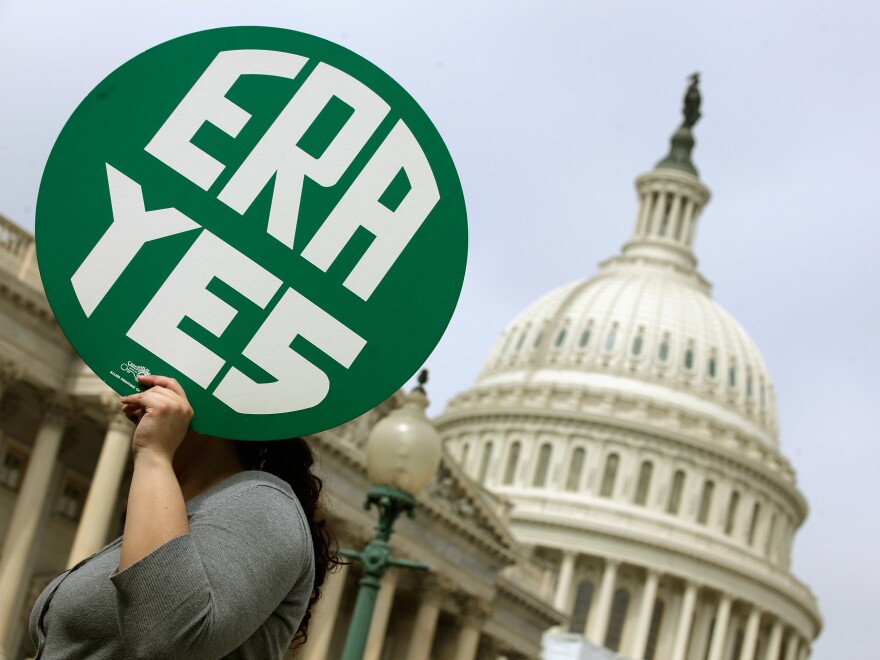 A woman holds up a sign as members of Congress and representatives of women's groups hold a rally to mark the 40th anniversary of congressional passage of the Equal Rights Amendment outside the Capitol in 2012.