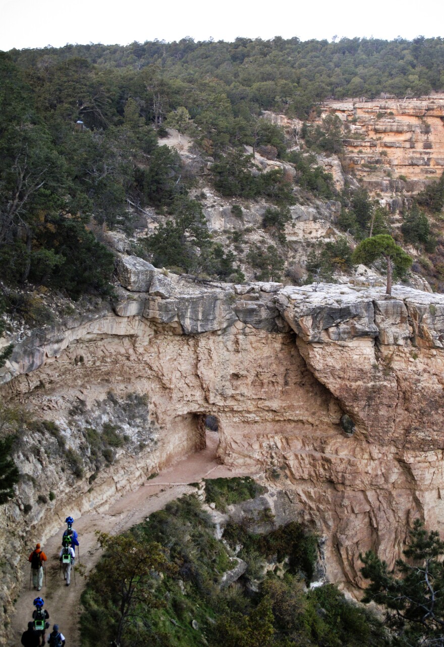 The Google Trekker team hikes down the Bright Angel trail heading toward the base of the Grand Canyon.