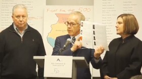 Attorney Jeff Anderson presents a 181-page report compiling sex abuse claims by Illinois priests as alleged victims Joe Iacono and Cindy Yesko look on.