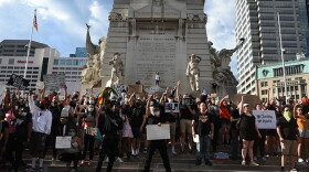 Protesters gathered at Monument Circle Tuesday evening after marching to the City-County Building and the Indiana Statehouse.