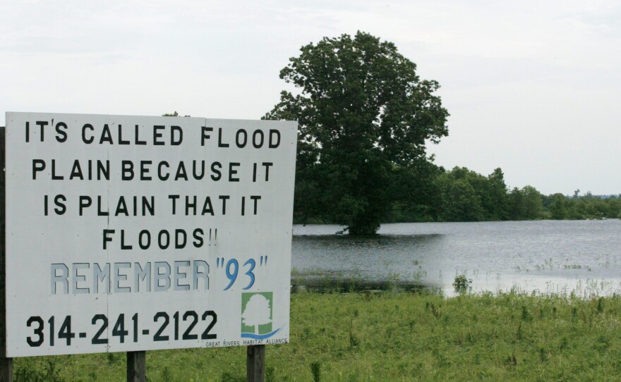 A sign in a field near Winfield, Mo., during a Mississippi River flood in 2008. The area suffered a similarly serious flood in 1993. The frequency of severity of flooding up and down the river have increased due to climate change and river control structures such as levees.