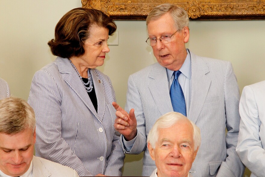 Sen. Dianne Feinstein (D-CA) talks with Senate Majority Leader Mitch McConnell (R-KY) before a photo op to celebrate National Seersucker Day at the U.S. Capitol Building on June 11, 2015 in Washington, DC.