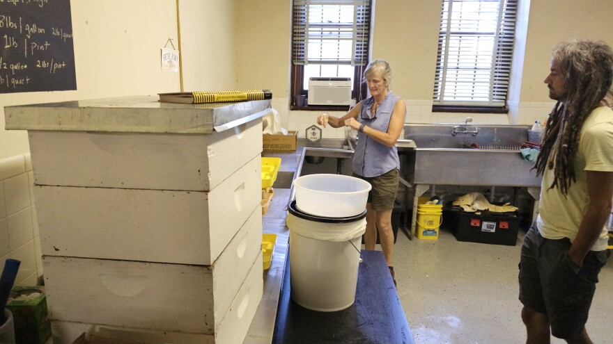 Master Gardener Ruth Landers shows off an apiarist's tools during the Growing Urban Farmers opening workshop on beginner beekeeping.