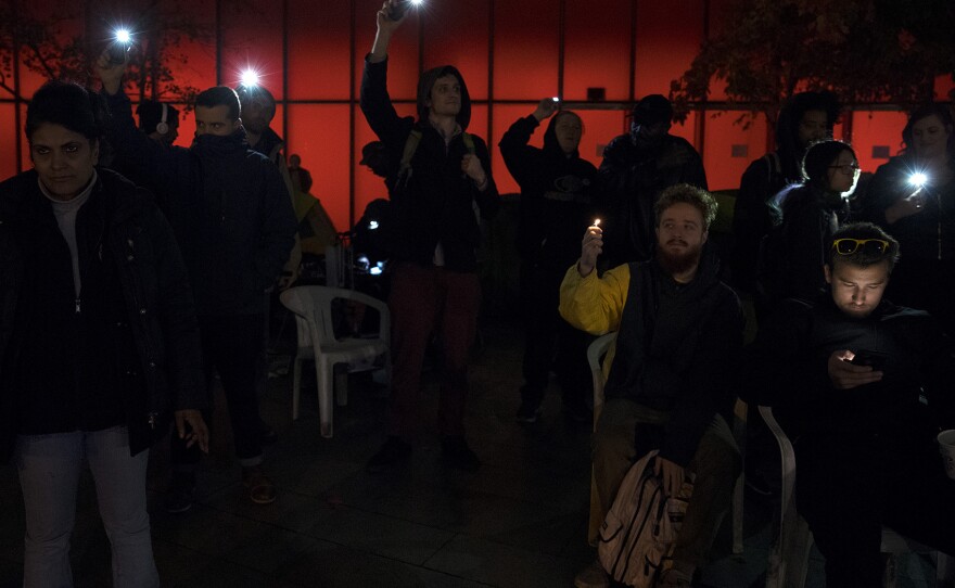 A crowd gathers outside of City Hall on Wednesday, November 1, 2017, to protest the sweeps of homeless camps in Seattle. 