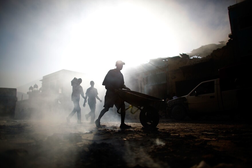 Business owners return to Port-au-Prince's commercial district to see what was left of their stores and to remove any goods that remained.