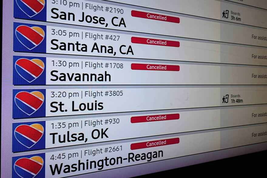 An arrivals and departures board reflects several flight cancellations in and out of Love Field Airport, Saturday, Jan. 24, 2026, in Dallas. (AP Photo/Tony Gutierrez)
