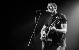 Matt Maeson plays his guitar as he sings onstage
