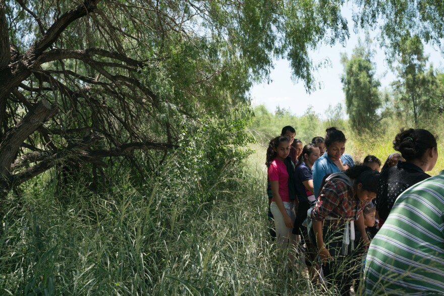 Some 25 people seeking asylum in the U.S. turn themselves in to Customs and Border Protection near McAllen on July 30.