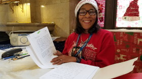 Post Office Quality of Working Life Coordinator Kimberly Davis holds some of the hundreds of letters sent to the post office this year seeking Santa's help for Christmas.