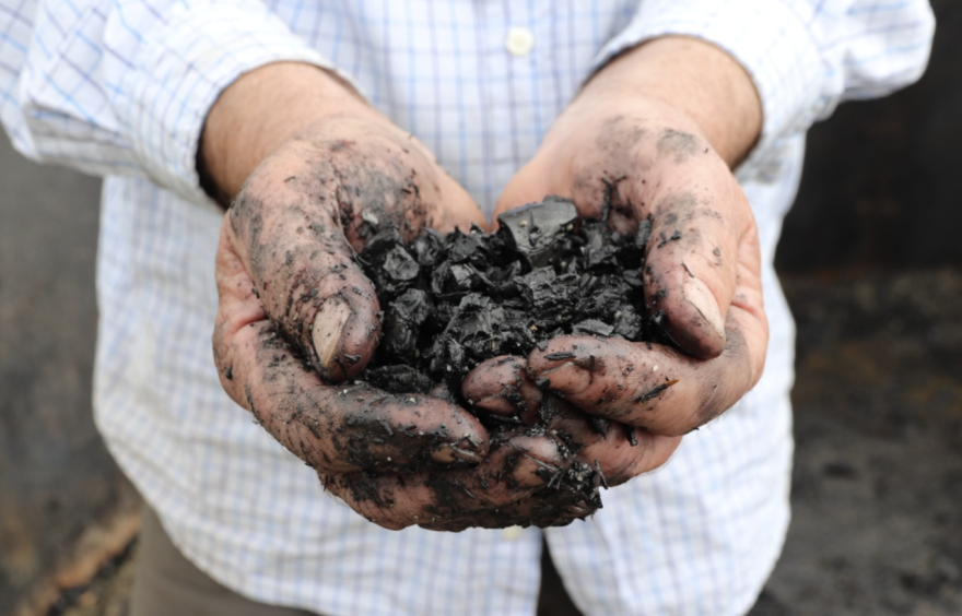 Darren McAvoy holds a handful of biochar.