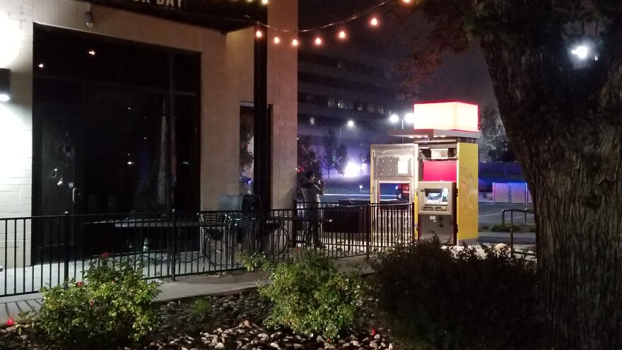 An ATM machine that has the door ajar because people broke it open.