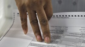Volunteer Sheryl Jackson pulls a vote out of box during an elections manual recount for three undecided races Friday, Nov. 16, 2018, in Tampa, Fla.