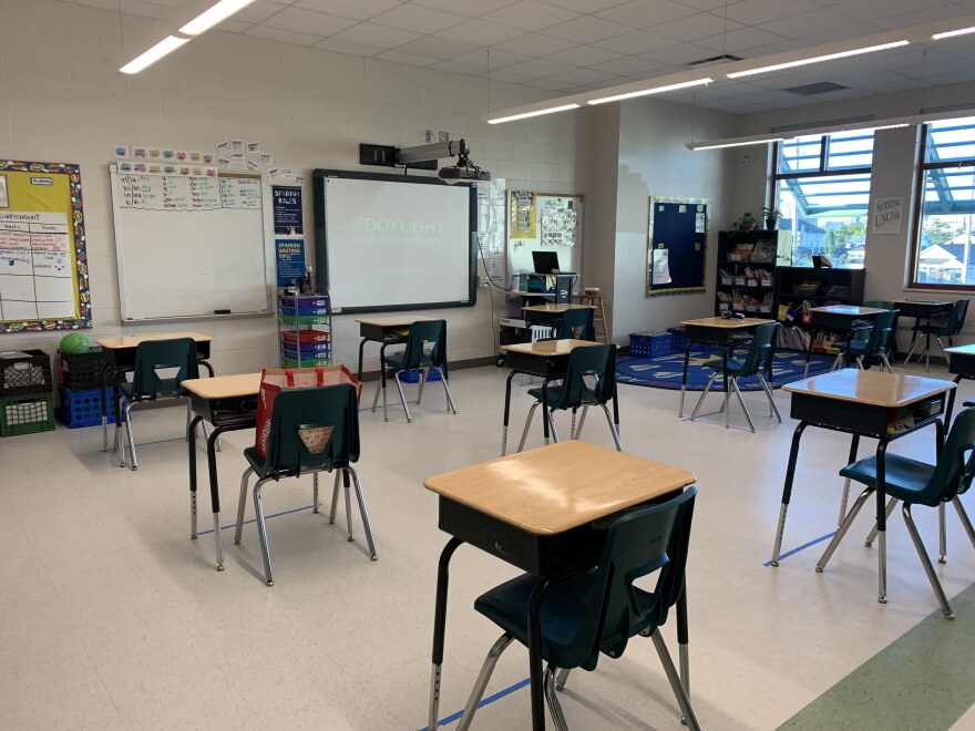 Kelli Gann's third grade classroom at Morris Jeff Community School. Desks are spaced more than six feet apart and students can see their virtual classmates projected on a screen at the front of the room.