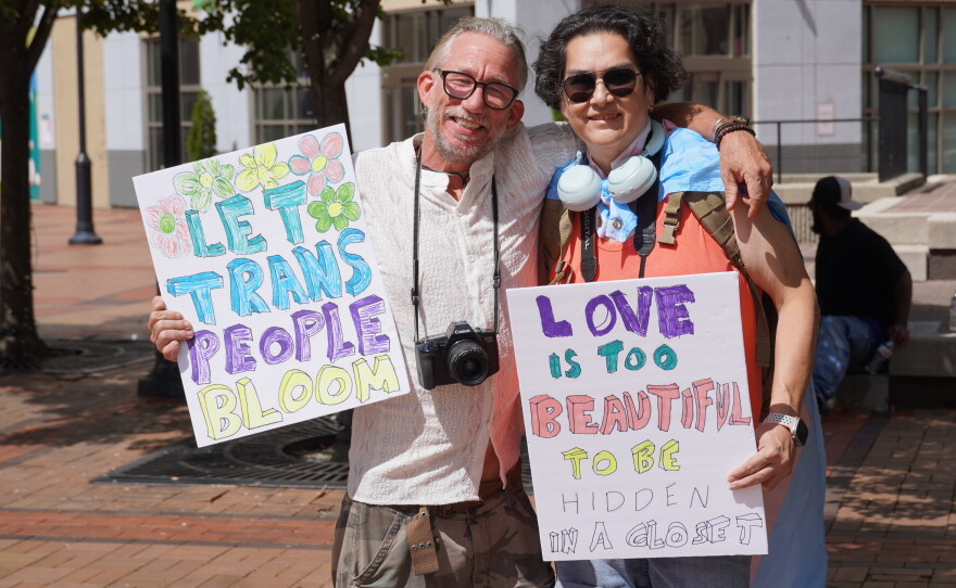 Images of supporters holding signs that they made for the protest.