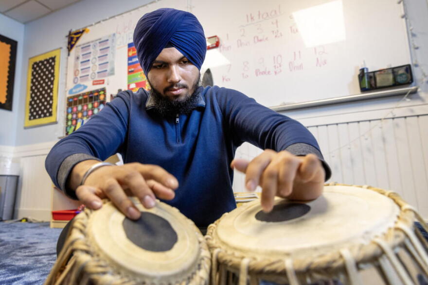 Ranveer Singh plays the tabla at the Gurdwara Guru Nanak Darbar in Medford, Mass.  (Robin Lubbock/WBUR)
