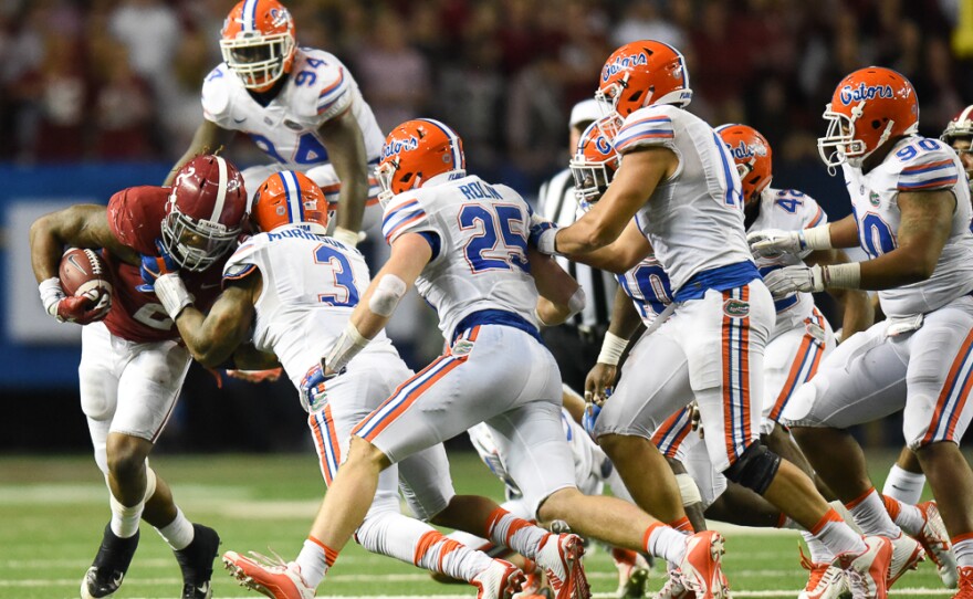 Florida linebacker Antonio Morrison (3) leads the charge on Alabama running back Florida defenders swarm Alabama running back Derrick Henry (2) in the second half. (Greenberry Taylor/ WUFT News)