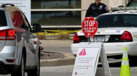 In front of Indiana University Health's Methodist Hospital, signs direct emergency room patients if they are experiencing COVID-19 symptoms.
