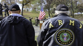 Veterans stand at attention as a color guard posts the colors during the Veterans Day ceremony in Eden Park on Nov. 11, 2019.