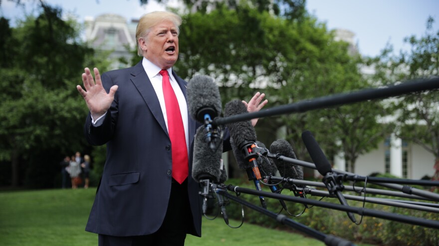 President Trump speaks to the media as he walks across the South Lawn while departing the White House on Wednesday in Washington, D.C.